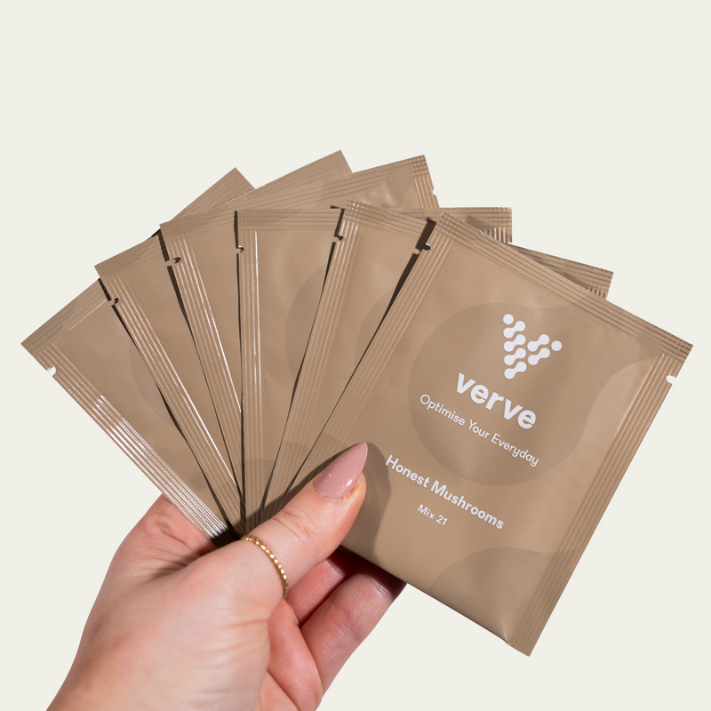 Person holding five brown Verve sachets labelled “Honest Mushrooms”.