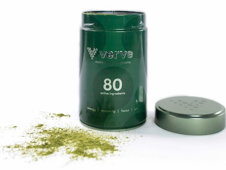 An open green Verve container labelled “80 active ingredients” with its lid placed beside it and green powder spilled on the white surface.