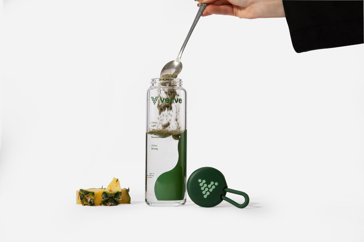 spoon dropping powder into bottle