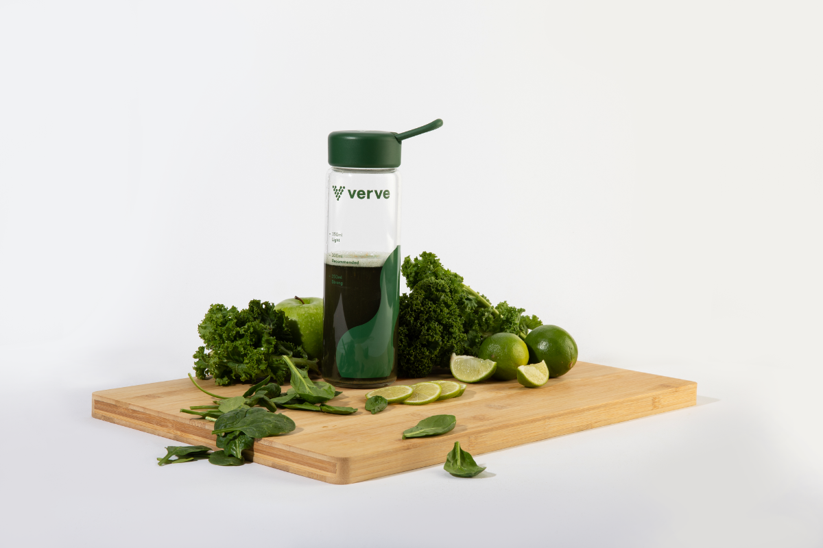 Bottle on board with green fruit