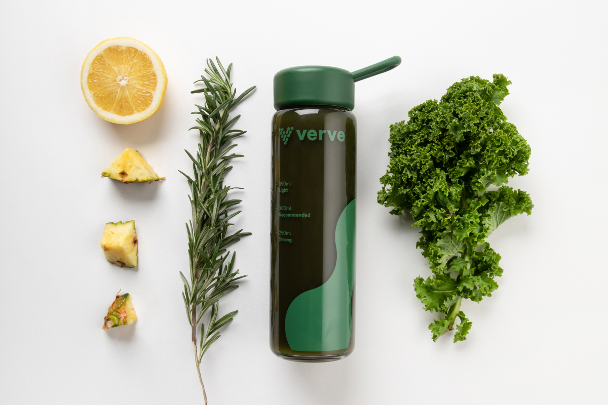 Verve bottle surrounded by kale rosemary and citrus