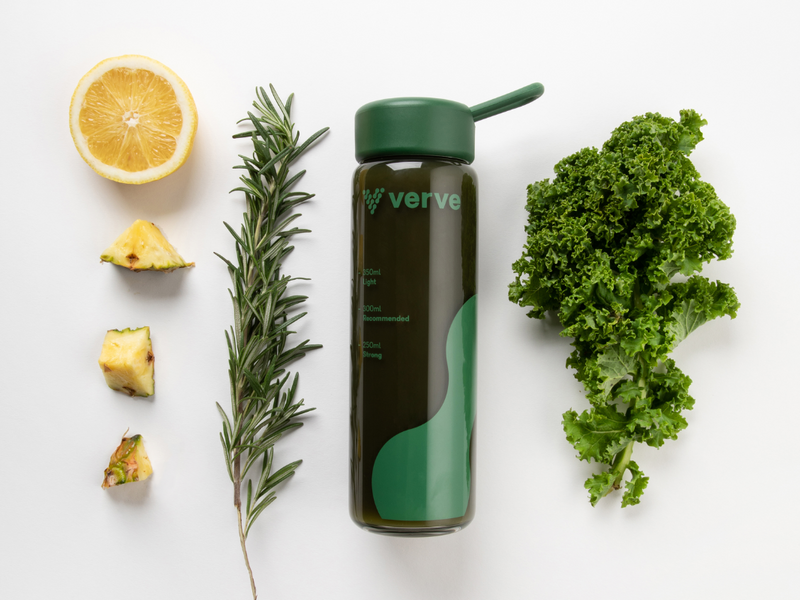 Verve bottle surrounded by kale rosemary and citrus