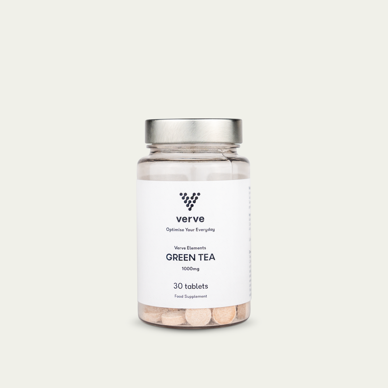A transparent glass bottle with a silver lid containing 30 Green Tea tablets (1000mg) by Verve, labeled as a food supplement.