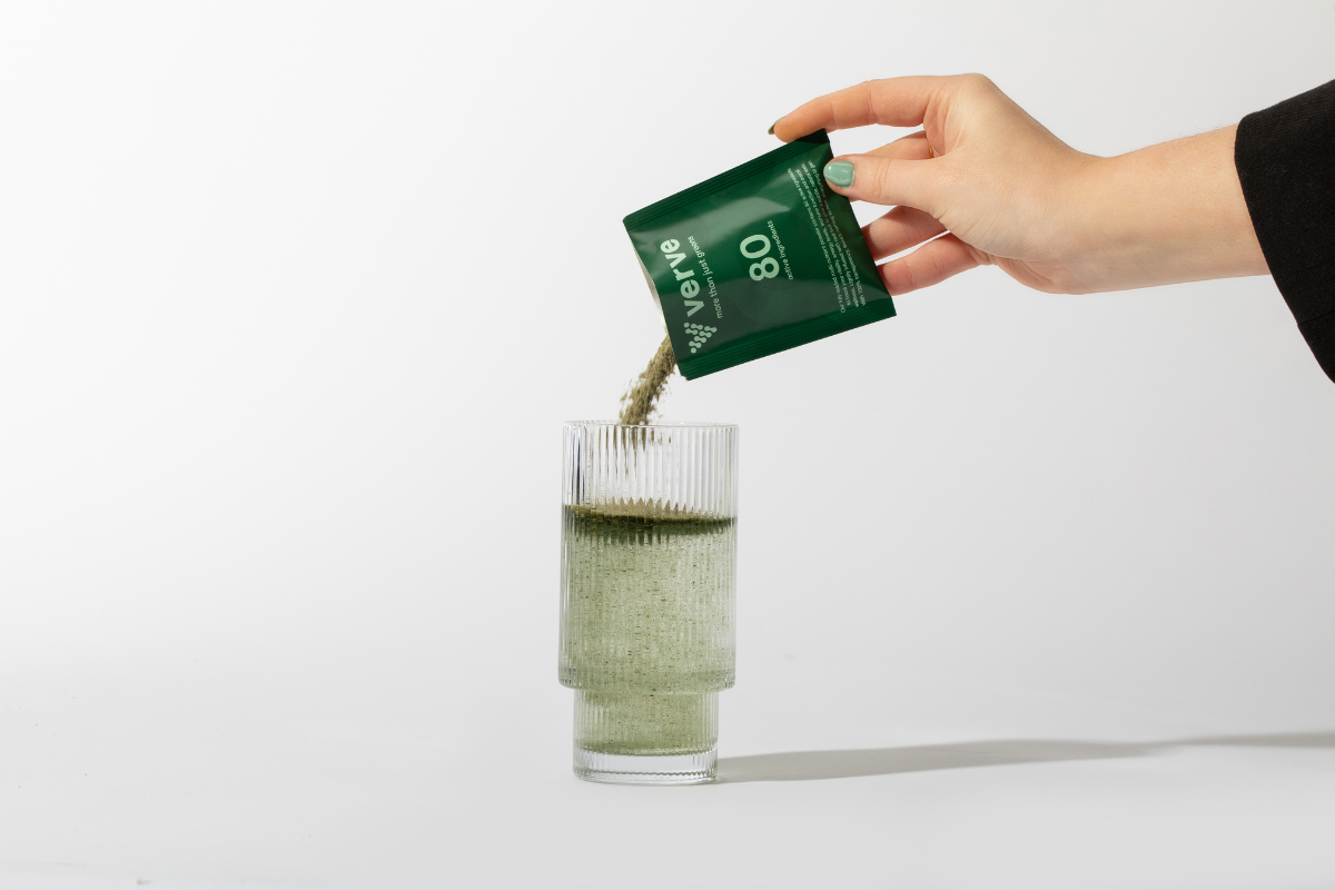 Verve Greens powder pouring into glass from sachet